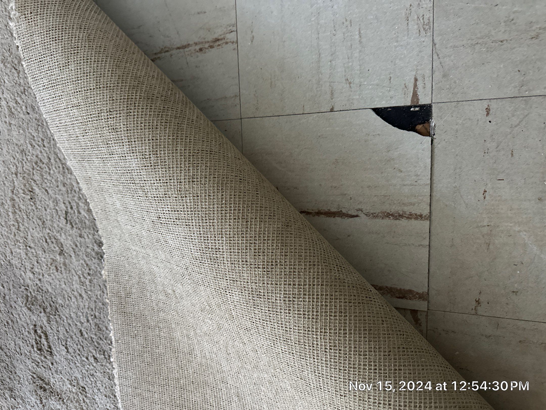 asbestos containing floor tile and mastic hidden under carpet